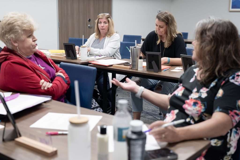 women in room being taught at retreat