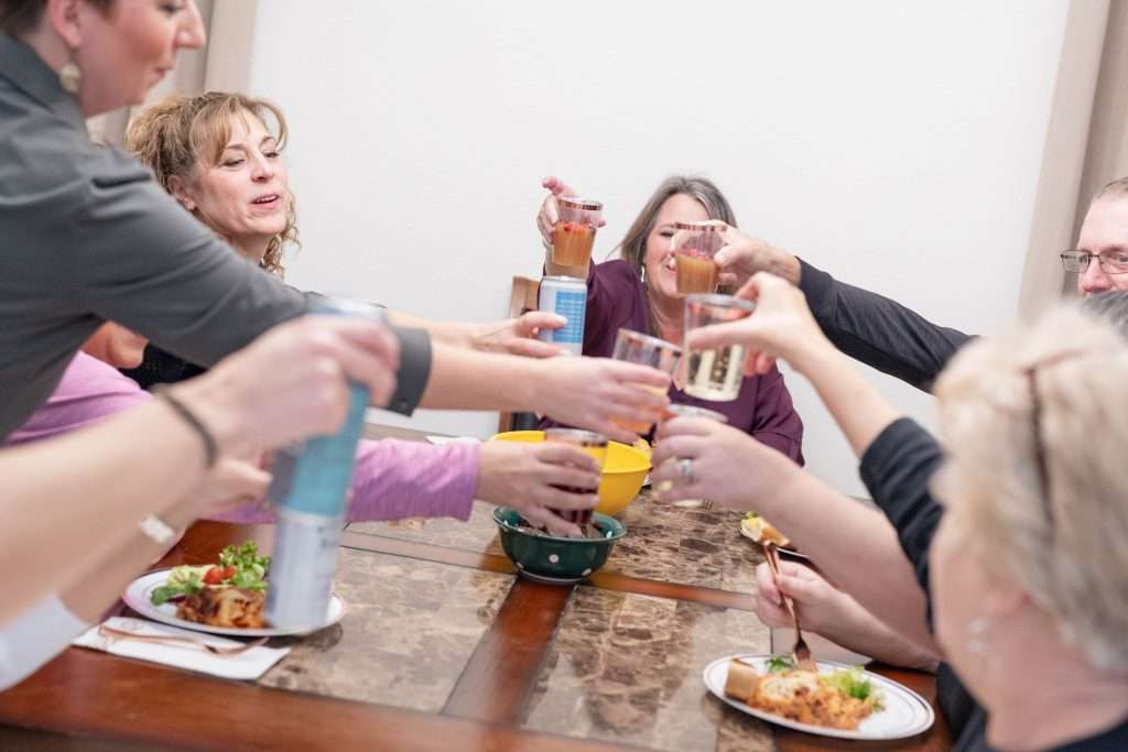 Dinner together at retreat, toasting everyone